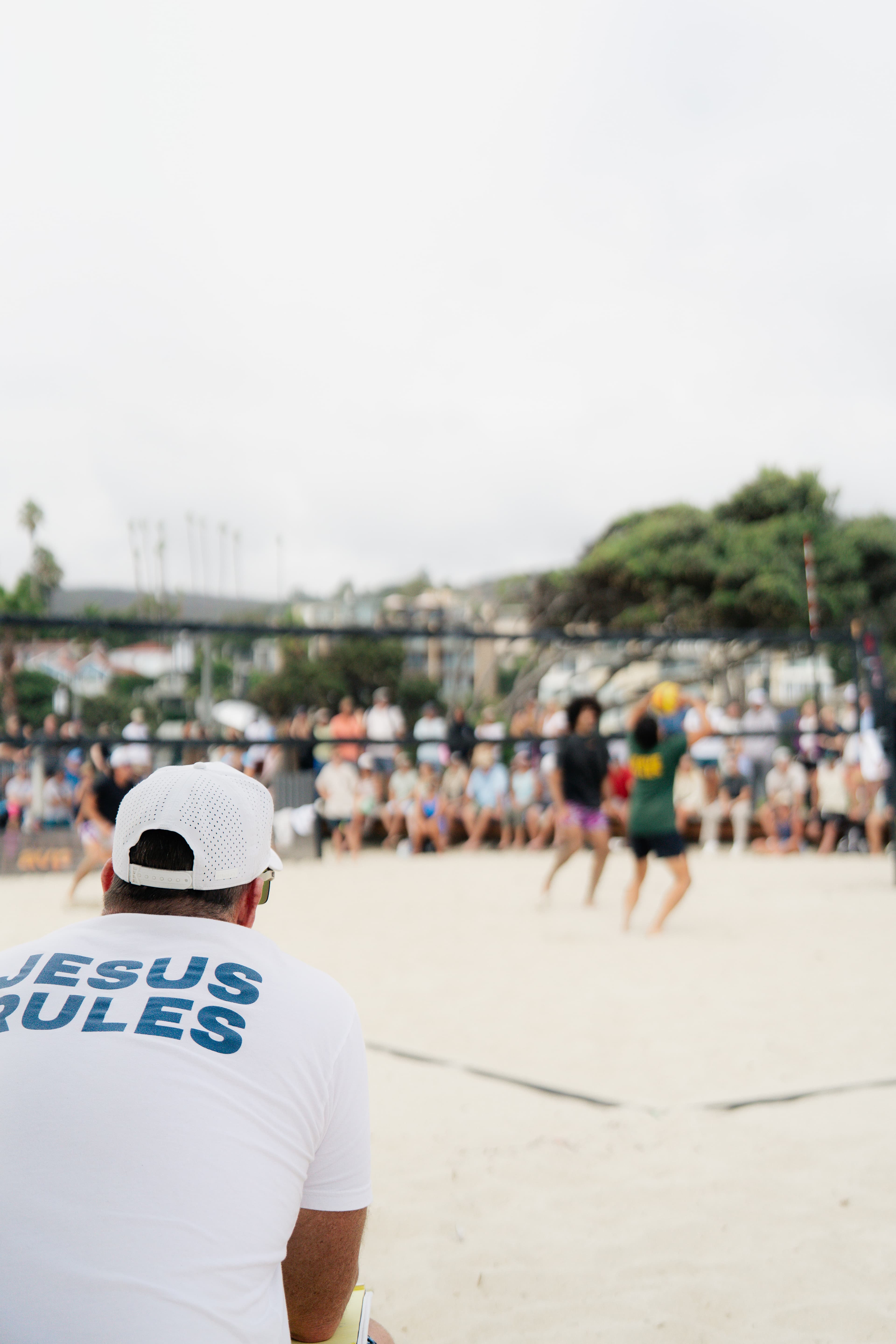 Michael watching match in Jesus Rules shirt