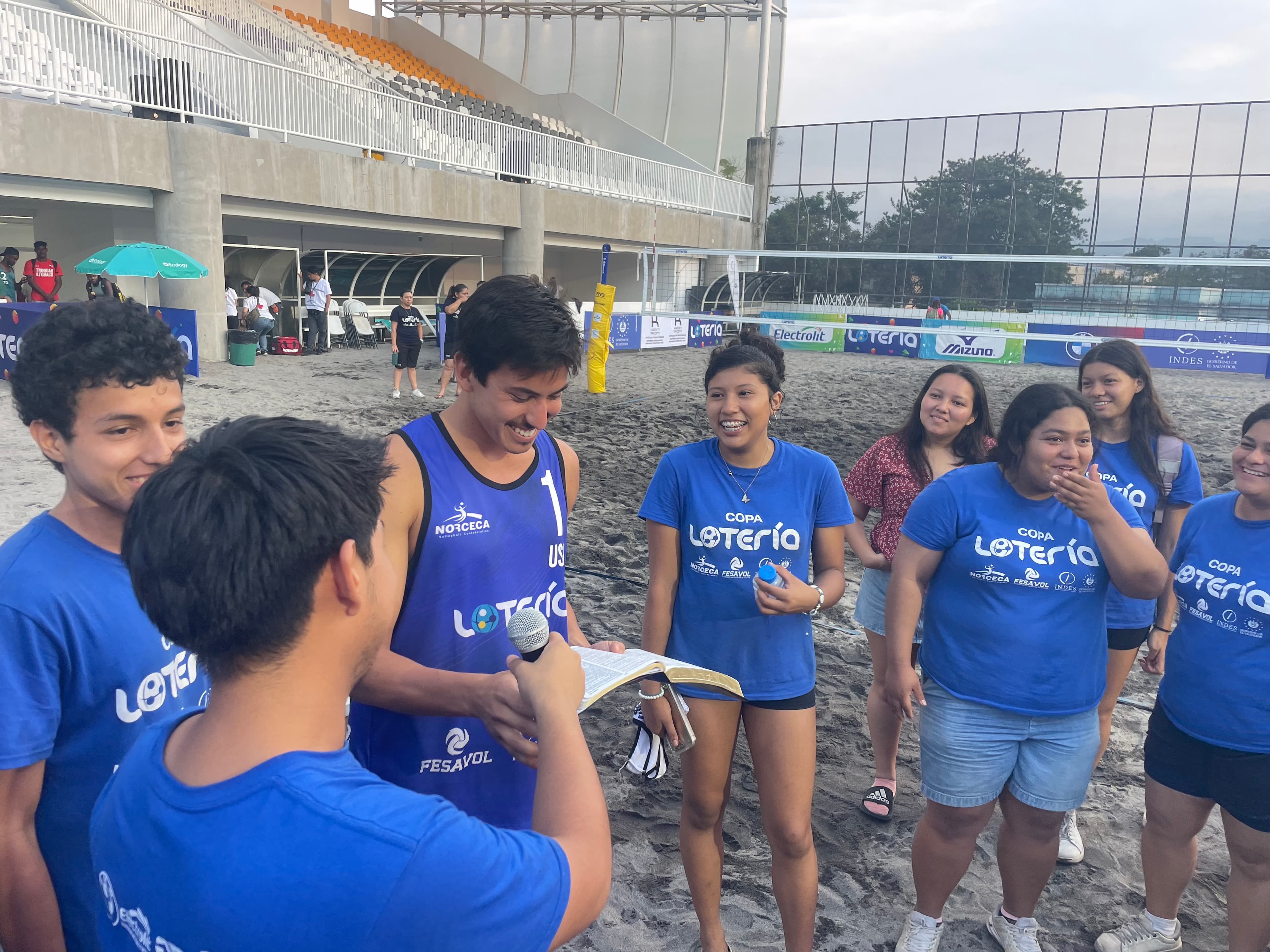 Diego speaking with Salvadoran youth at a beach volleyball clinic